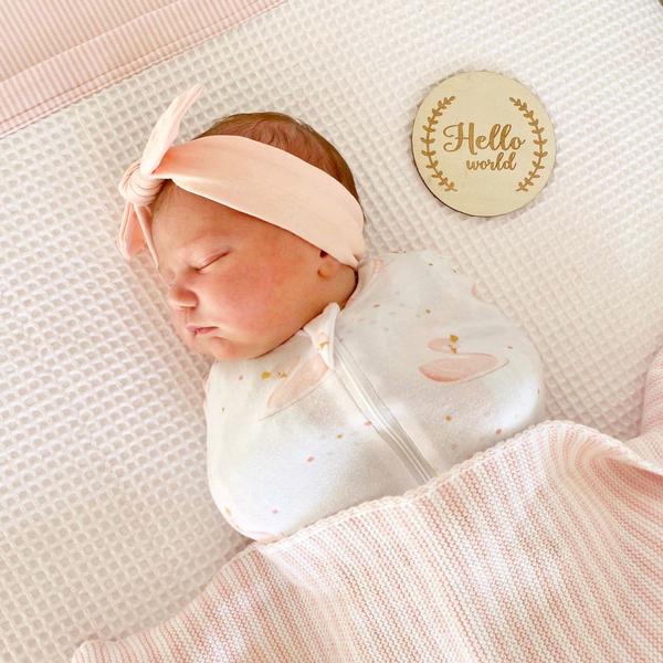 The Living Textiles luxuriously soft 100% cotton jersey swaddles make swaddling a breeze. Featuring a hip healthy design and 2-way zip so you can change baby without waking them. Swaddling can be a great way to keep baby from being disturbed by their own startle reflex and make them feel warm and secure as if they were cocooned in the womb. 